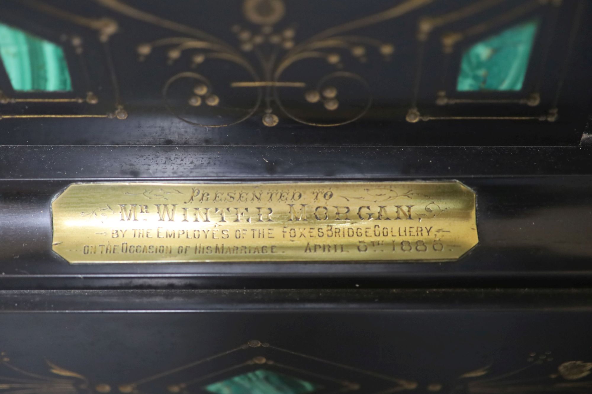 A Victorian black marble and inlaid malachite eight day mantel clock, plaque reads Presented to Mr Wintermorgan by the employees of